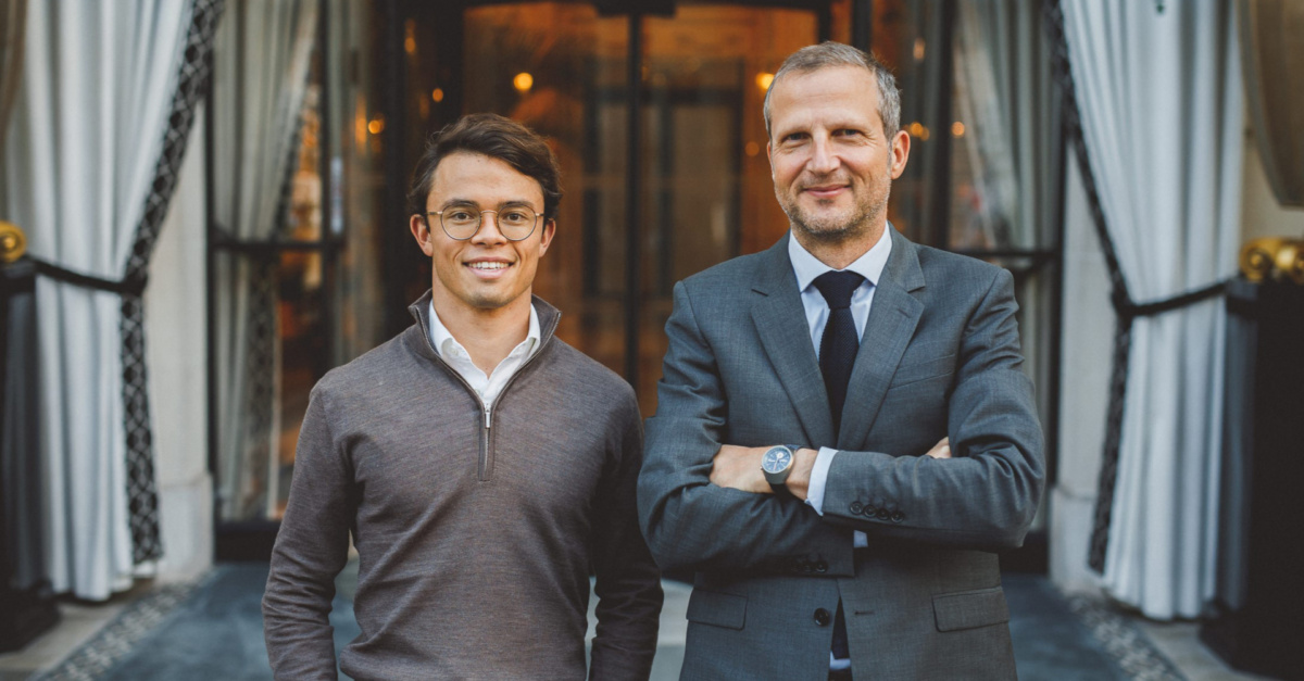 Serge Savasta, CEO of Omnes, stands confidently in a suit next to Nick de Vries, wearing glasses and a casual sweater.